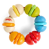 Colorful wooden rainbow rattle with six plastic rings, designed for baby grasping and teething development.