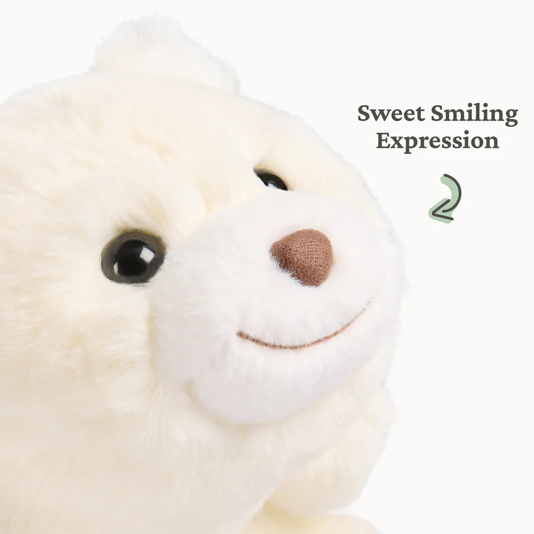 Close-up of a small plush with soft cream fur and a sweet smiling expression for cuddling on the go