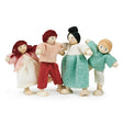 Four wooden dolls dressed in colorful fabric clothes representing a happy family in playful poses