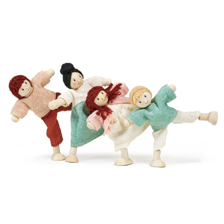 Four handcrafted wooden dolls dressed in colorful fabric clothes posing playfully on a white background