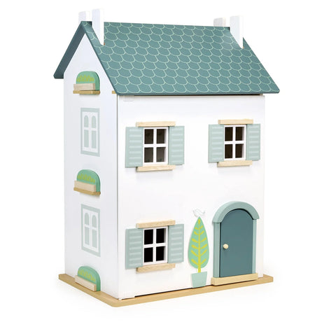 Medium-sized wooden dollhouse with three floors, blue roof, shutters, and a charming front door design