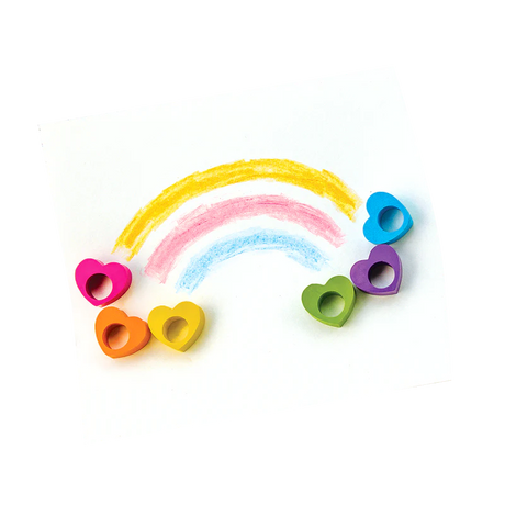 Heart Ring Crayons in six colors shaped like hearts, arranged with rainbow crayon drawings on white paper.