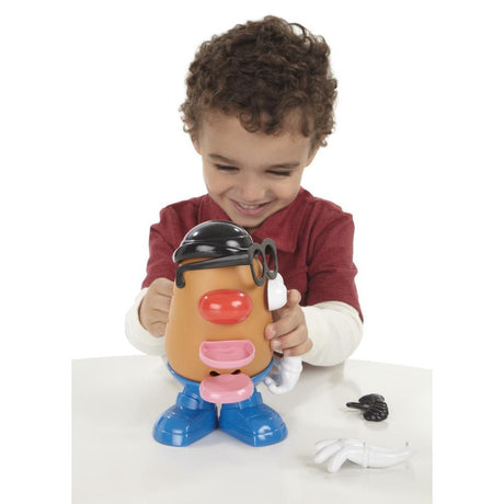 Child playing with Mr. Potato Head toy featuring mix-and-match parts and accessories for creative fun.
