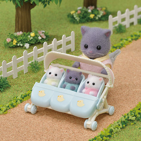 Triple Stroller with chick-pattern seat covers fitting three baby toys side by side on a path outdoors.