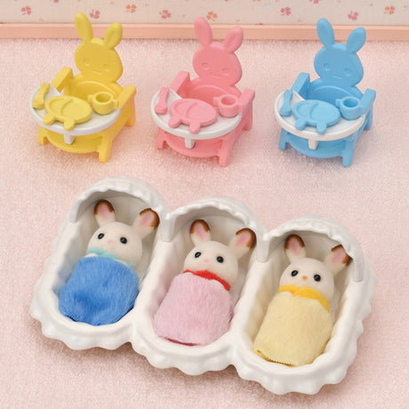 Triplets Care Set with three cradled bunny babies in colorful clothes and matching baby chairs and feeding sets.