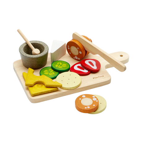 Charcuterie Board with wooden cheese slices, pickles, salami, strawberries, knife, sauce cup, spoon, and cutting board set for kids.