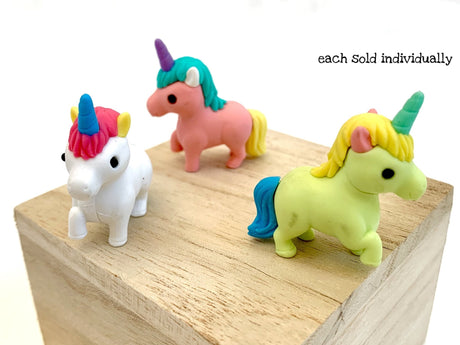 Japanese Eraser Unicorn featuring colorful, pocket-sized, hand-assembled puzzle erasers displayed on a wooden block.