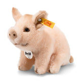 Sissi Piglet plush toy in pale pink woven fur with safety eyes, curly tail, and Steiff "Button in Ear" trademark sitting pose.