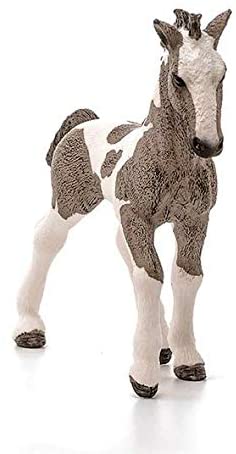 Tinker Horse Foal figurine with piebald coat, detailed mane, tail, and fetlocks, depicting a gentle and sturdy breed.