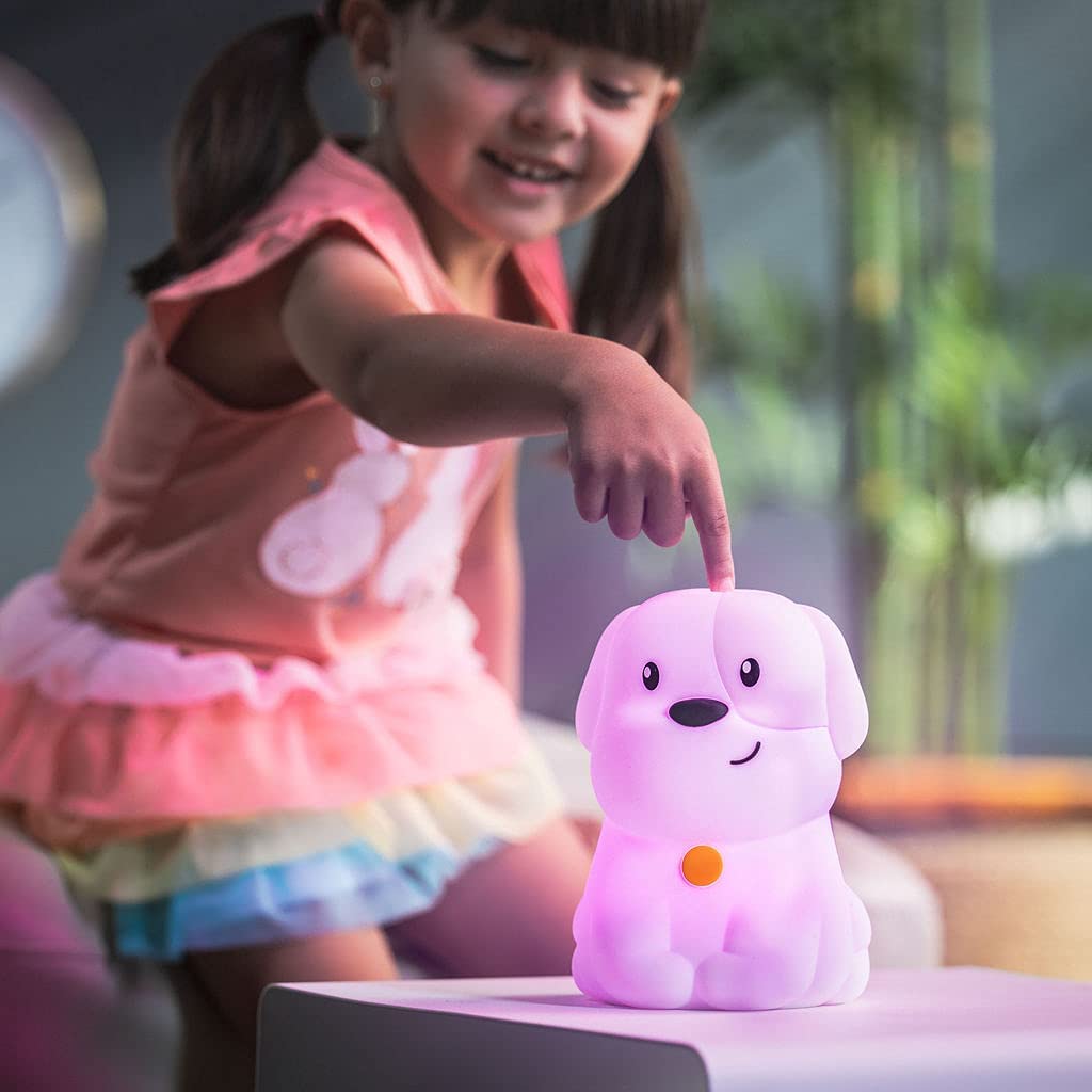 Girl playing with glowing LED Nightlight | Puppy, a soft, portable nightlight with soothing colors and easy tap controls.