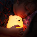 LED Nightlight | Bear softly glowing in warm light held by child for comfort and bedtime calm.