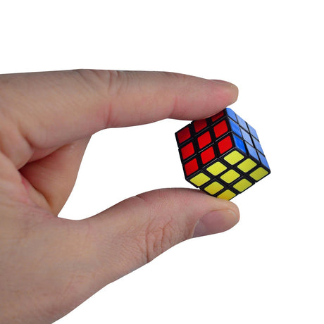 Hand holding the World's Smallest Rubiks cube, a compact 3x3 puzzle challenge for brain teaser fans.