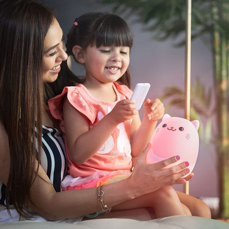 LED Nightlight | Cat with glowing pink light held by a smiling child and mother using a remote control.