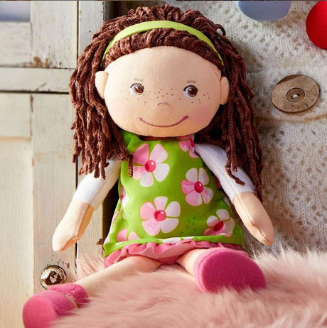 Coco Doll with embroidered face, brown hair, green floral dress, and pink shoes, perfect for toddler cuddles and playtime.