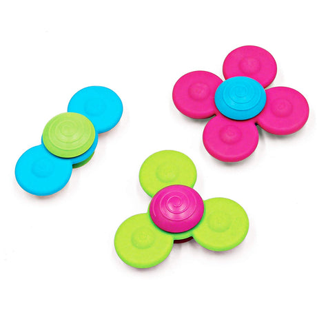 Three colorful silicone Whirly Squigz spinners with suction cups for sensory play and teething relief.