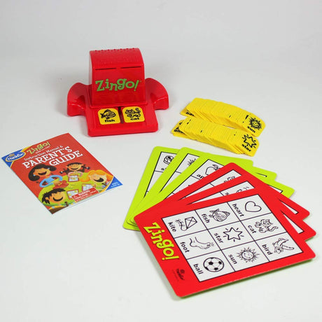 Zingo game with red tile dispenser, picture cards, yellow tiles, and a colorful parent’s guide booklet.