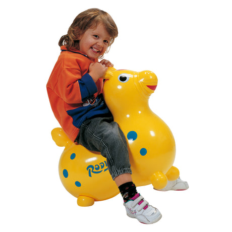 Child happily sitting on the yellow Rody | Yellow toy horse, developing balance and coordination skills.