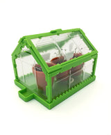 Tiny Tools Tiny Gardening miniature desktop greenhouse with clear panels and tiny pots for seedling growth and plant science activities.