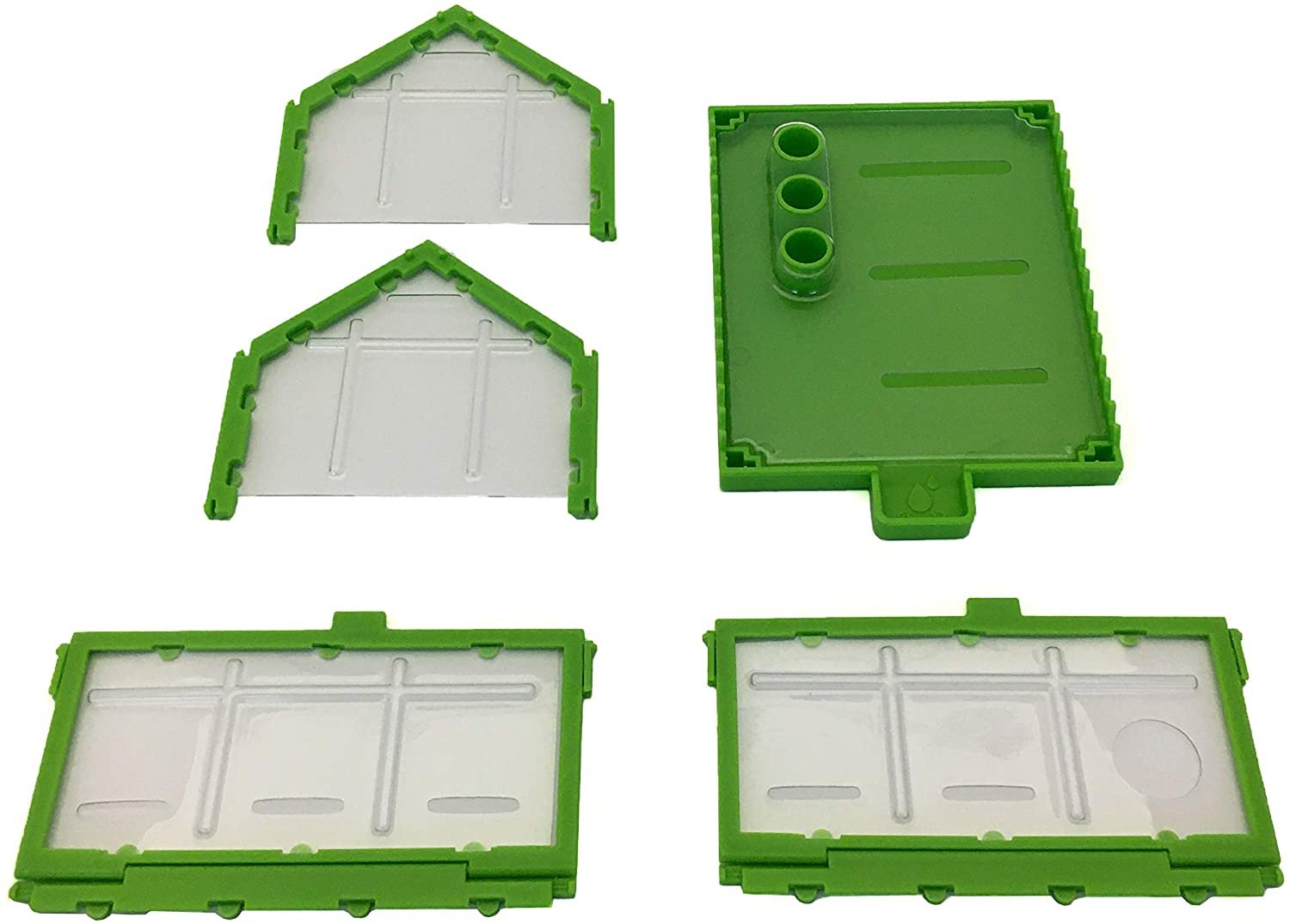 Parts of the green and clear tiny greenhouse from the Tiny Tools Tiny Gardening kit laid out separately.