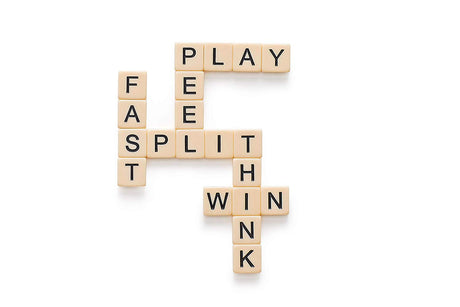 Bananagrams letter tiles forming words fast, play, split, think, and win on a white background.