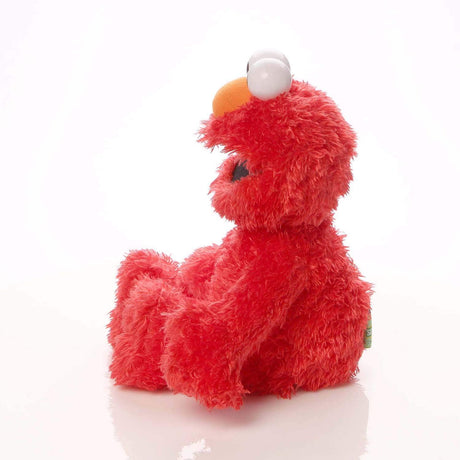Elmo plush from Sesame Street in bright red with soft fur, 13-inch cuddly toy perfect for all ages.