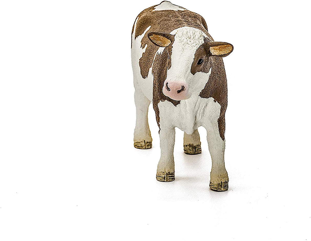 Simmental Cow figurine showing white head and legs with reddish-brown patches, detailed and lifelike model.