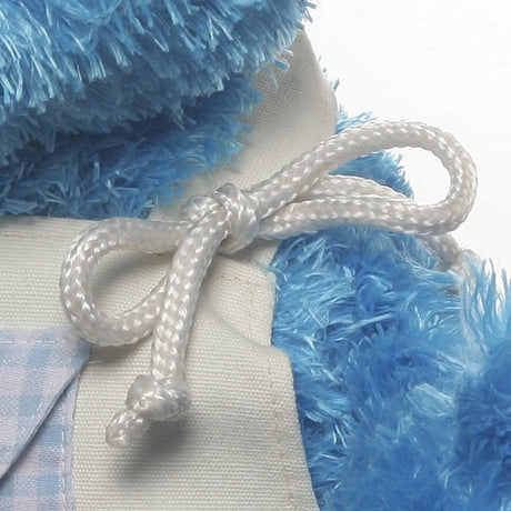 Close-up of Teach-Me Cookie Monster plush’s tied white apron string on soft blue fur stuffed toy.