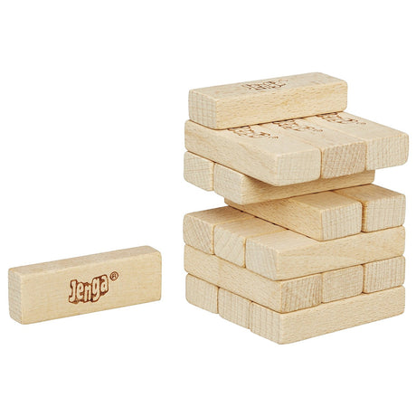 Jenga Mini wooden blocks stacked in a tower with one block pulled out ready for the next move in the game.