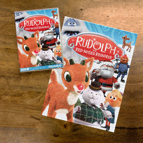 300pc Rudolph VHS Puzzle showing completed puzzle and box with classic Rudolph the Red-Nosed Reindeer VHS cover art.