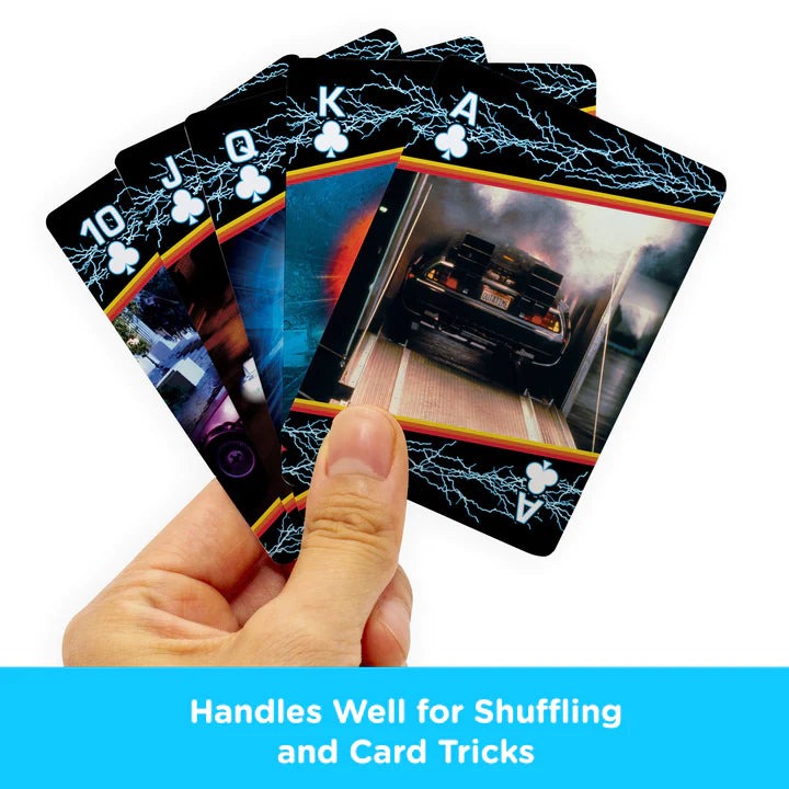 Hand holding Back to the Future Playing Cards showing lightning border and iconic movie scenes on standard poker cards.