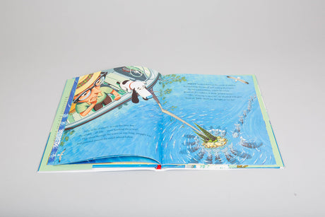 Open illustrated children’s book page from Down to the Sea With Mr Magee showing Mr. Magee and dog Dee in a boat near the sea.