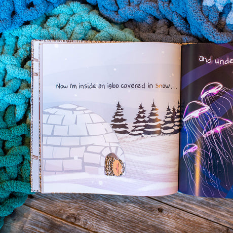 Open book of Blanket: Journey to Extreme Coziness showing an igloo illustration and cozy blanket background.