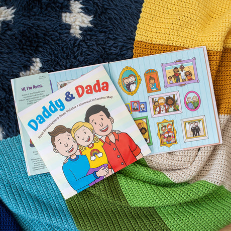 Daddy & Dada book cover and open pages showing a child with two dads in a colorful, cozy setting.