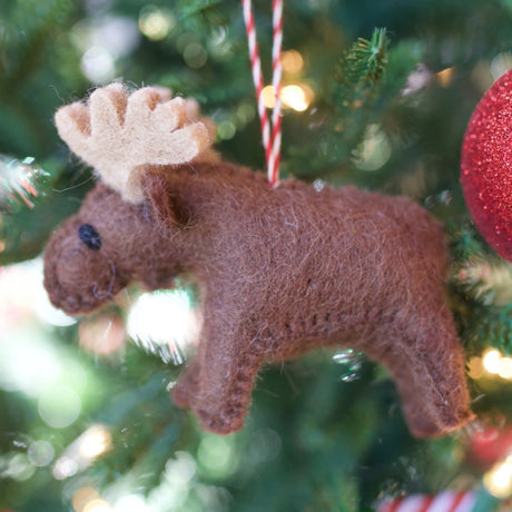 Moose Felt Ornament hangs on Christmas tree, handmade wool craft showing a charming brown moose decoration.