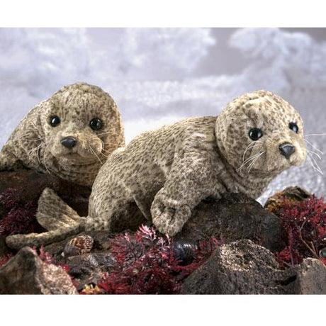 Harbor Seal Puppet featuring two soft, realistic seals with black eyes and whiskers on rocky ocean floor set.