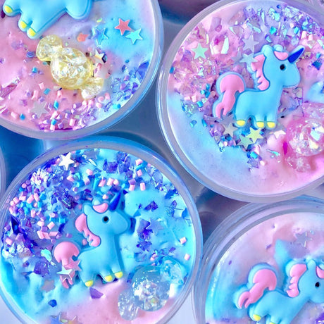 Don't Feed the Unicorns Butter Slime with pastel colors, unicorn charms, holographic stars, and glitter sprinkles.