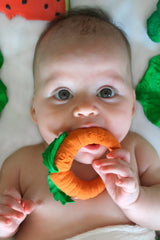 Baby chewing on Natural Teether | Cathy the Carrot made of 100% natural rubber, safe and soft for teething.