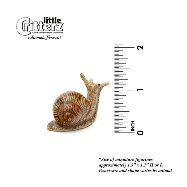 Critterz Garden Snail Helix miniature porcelain figurine next to ruler measuring approximately 1.25 inches tall.