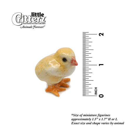Critterz Baby Chick Peeps miniature porcelain figurine next to a 2-inch ruler for size reference.