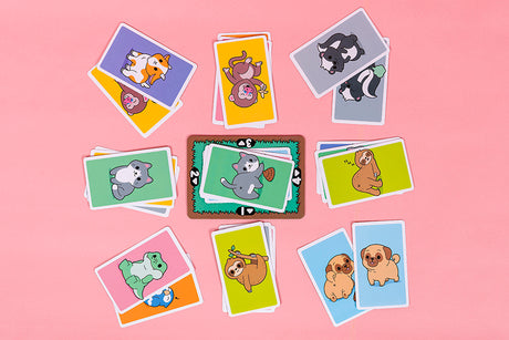 May Contain Butts card game with colorful animal front and butt matching cards on pink background.