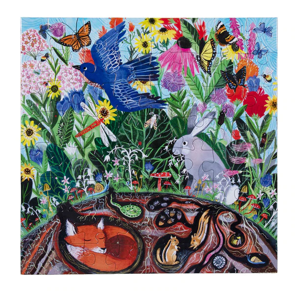 64pc Wild Things Puzzle showing colorful garden animals, birds, flowers, and underground wildlife in a vibrant natural scene.