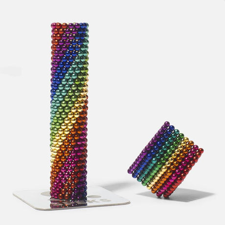 Speks. Spectrum. colorful rare earth magnetic balls arranged in vertical and tilted formations as a fun desk toy.