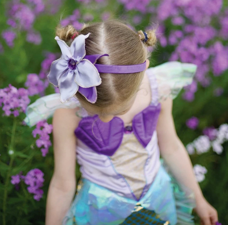 Little girl in Mermaid Dress & Headband Lilac | Size 5-6 with purple shells and holographic sea blue skirt in garden.