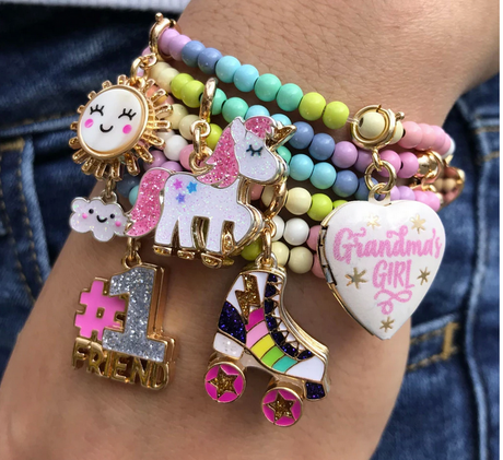 Pastel Bead Stretch Bracelet with colorful beads and cute charms including unicorn, roller skate, and #1 friend charm.