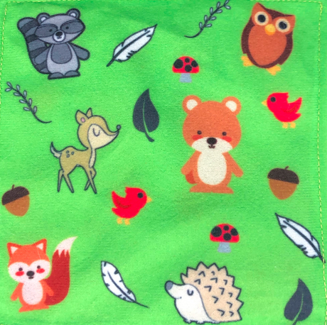 Baby Paper | Woodland showing colorful forest animals like bear, fox, owl, hedgehog, and raccoon on green fabric.