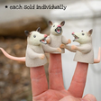 Finger Possum finger puppets shown on fingers, soft vinyl 2" tall playful and philosophical toy sold individually.