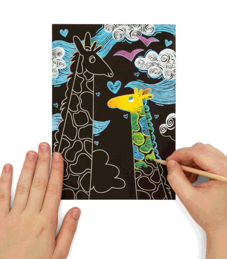 Scratch & Scribble Monster Pals showing a hand coloring a giraffe on a scratch art card with bright patterns revealed.