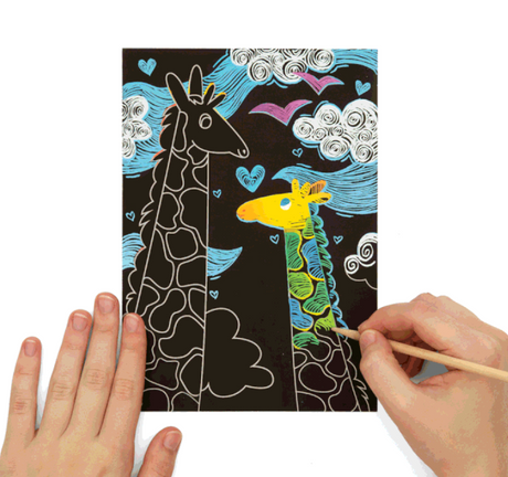 Scratch & Scribble Magical Unicorns showing a hand revealing colorful giraffe art with a wooden scratching tool.
