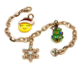 Gold Snowflake Charm with sparkling crystals on a gold chain bracelet featuring festive holiday charms.