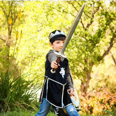 Young child dressed as a knight holding the Sting Sword, a 28-inch foam play sword for imaginative battles.